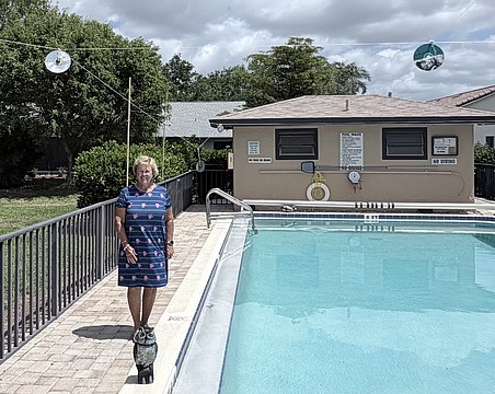 Sharon Godlewski stands by the pool at Springlake in The Meadows. Only the owl and CDs remain, but it's enough to keep the ducks away.