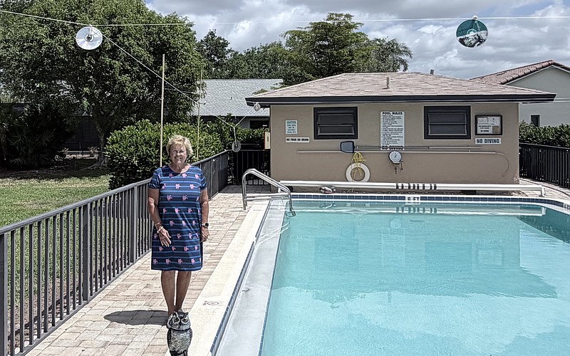 Sharon Godlewski stands by the pool at Springlake in The Meadows. Only the owl and CDs remain, but it's enough to keep the ducks away.