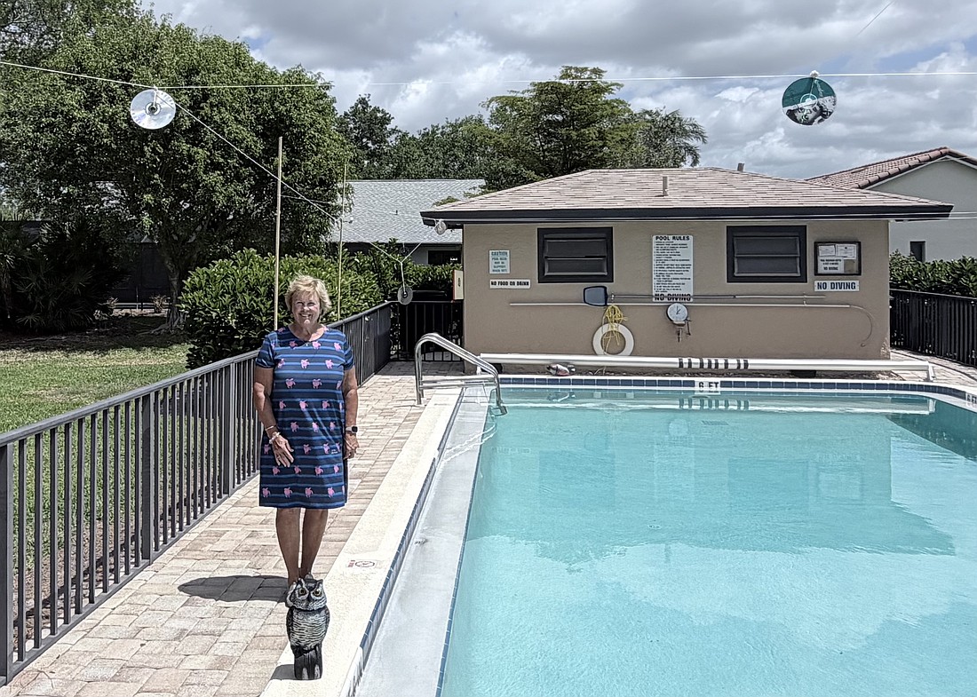 Sharon Godlewski stands by the pool at Springlake in The Meadows. Only the owl and CDs remain, but it's enough to keep the ducks away.