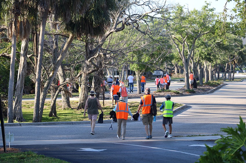 After gathering their supplies at 8:30 a.m. outside Temple Beth Israel, the 60-some volunteers started out on their mission to clean up the roadways along Gulf of Mexico Drive and Bay Isles Road.