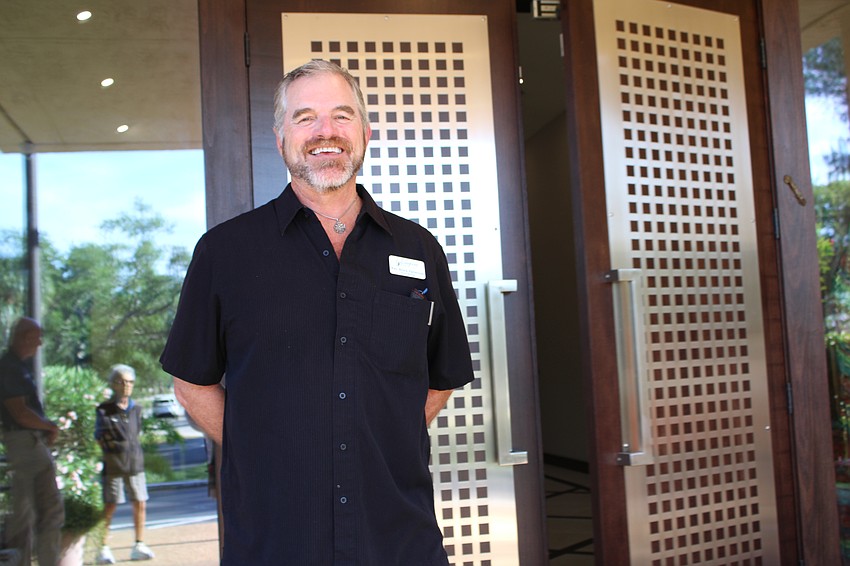Longboat Island Chapel's Rev. Brock Patterson welcomes people back and helps collect cleanup gear.