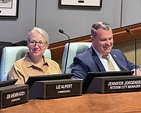 Patrick Robinson at the dais with Interim City Manager Jennifer Jorgensen during a recent City Commission meeting.