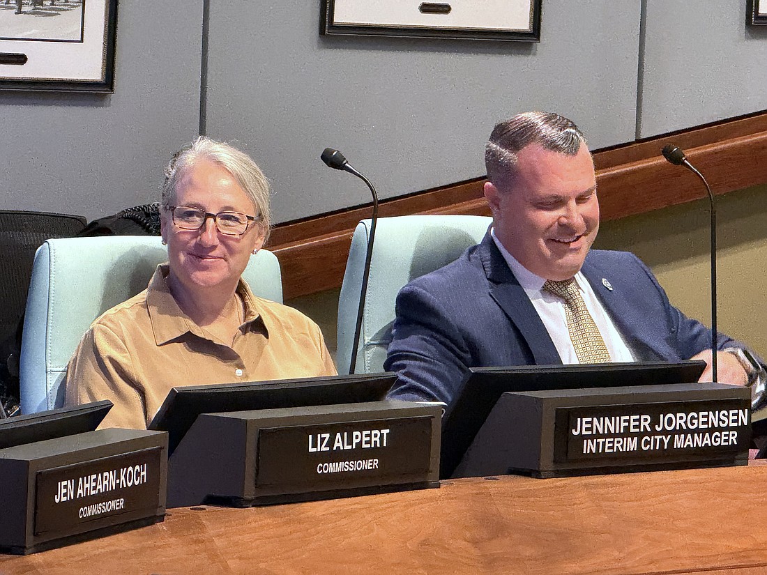 Patrick Robinson at the dais with Interim City Manager Jennifer Jorgensen during a recent City Commission meeting.