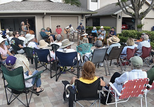 A crowd gathers outside as the Driveway Drifters perform. The members pictured include Angie Eason, Gary Bowen, Debbie and Ron Fellman, Bill Green, Gary Eason, Lynn Cassell, Mike Lawless and Michael Cohen. One band member, Eugene Moleiro, was not in attendance.