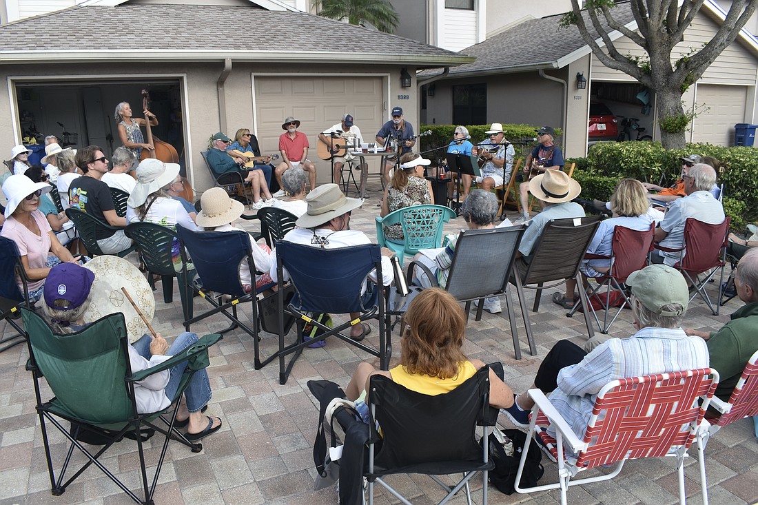 A crowd gathers outside as the Driveway Drifters perform. The members pictured include Angie Eason, Gary Bowen, Debbie and Ron Fellman, Bill Green, Gary Eason, Lynn Cassell, Mike Lawless and Michael Cohen. One band member, Eugene Moleiro, was not in attendance.