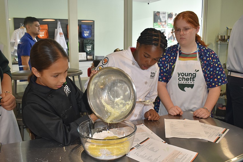 Fifth grader Ryker Voyles, fourth grader Mia Rumph and seventh grader Meadow Polley bake coffee cakes.