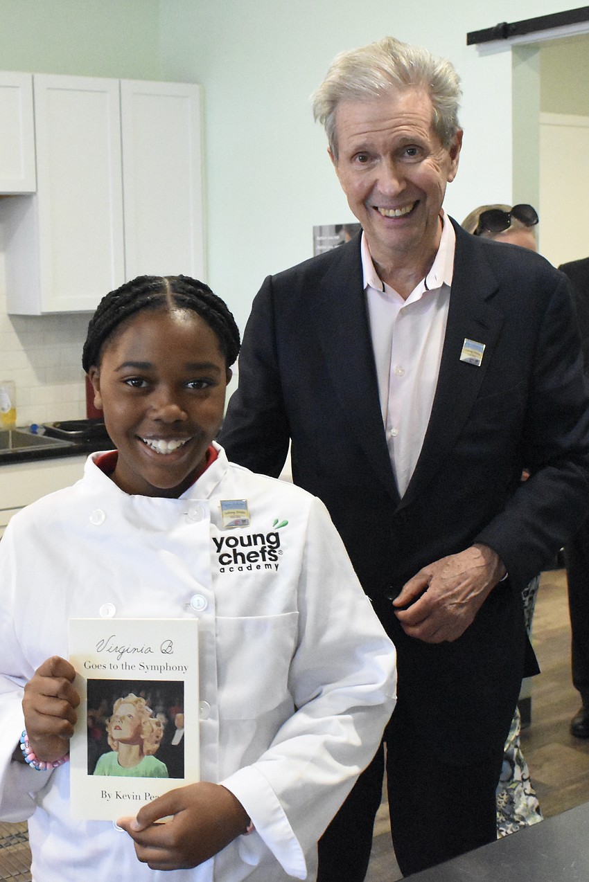 Fourth grader Mia Rumph stands beside Alexander Sanger, a trustee of the Virginia B. Toulmin Foundation.