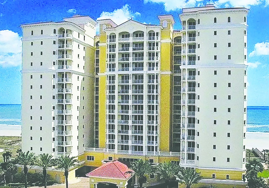 Oceanfront condo features four bedrooms, four full and one half bathrooms, porches, two-car indoor parking, a storage room and community amenities.