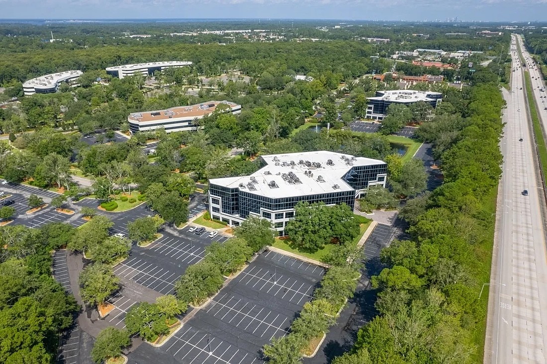 NAI Hallmark Partners is listing two Prominence Office Park buildings for sale. Building 500 at 8381 Dix Ellis Trail is in the lower part of the photo. Building 600 at 8375 Dix Ellis Trail is above it. They are along Interstate 95.