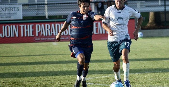 Forward Jonathan Bolanos (right) dribbles with a defender on his tail during the Sarasota Paradise's match vs. Corpus Christi FC on April 22. It was the team's first win this month, and second in seven games played.