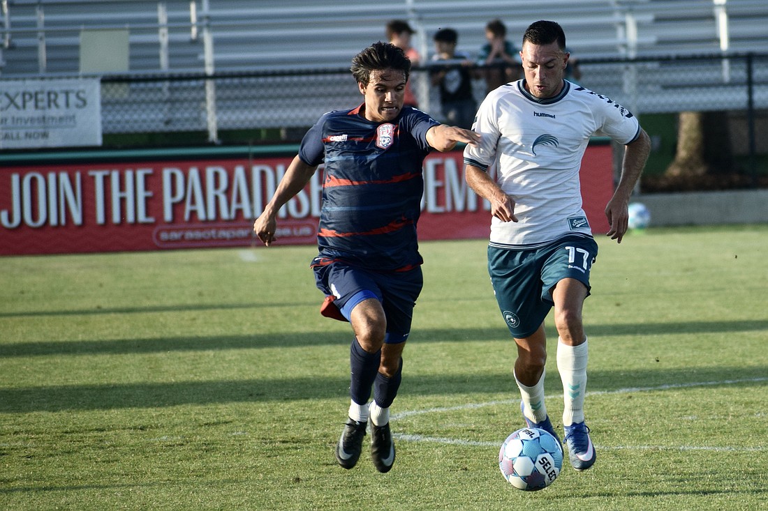 Forward Jonathan Bolanos (right) dribbles with a defender on his tail during the Sarasota Paradise's match vs. Corpus Christi FC on April 22. It was the team's first win this month, and second in seven games played.