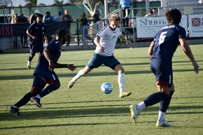 Midfielder Ethan Bryant (center) weaves through Corpus Christi FC defenders. He's registered three shots in seven games played.