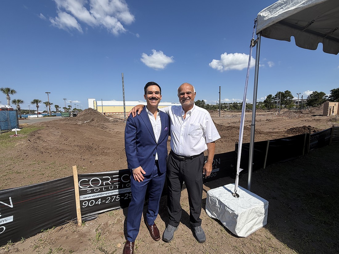 Sleiman Enterprises President Toney Sleiman, right, with his son, Hunter Sleiman, at the site where Sleiman Enterprises is developing a Harris Teeter grocery store in the Atlantic North shopping center.