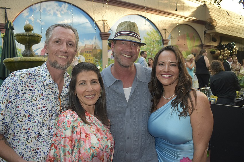 Kevin Klein, Rita Radi, Tyson Babb and Lisa Warren-Wallace spend time in the courtyard.