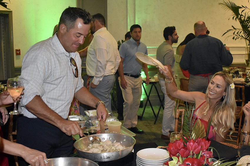 Nick Esposito is fanned by Jennifer Esposito as he cooks.