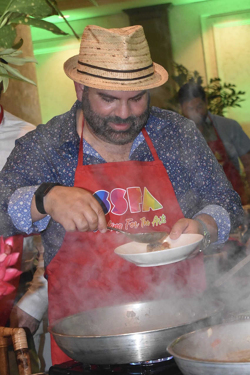 Oscar Callejas fills a dish.