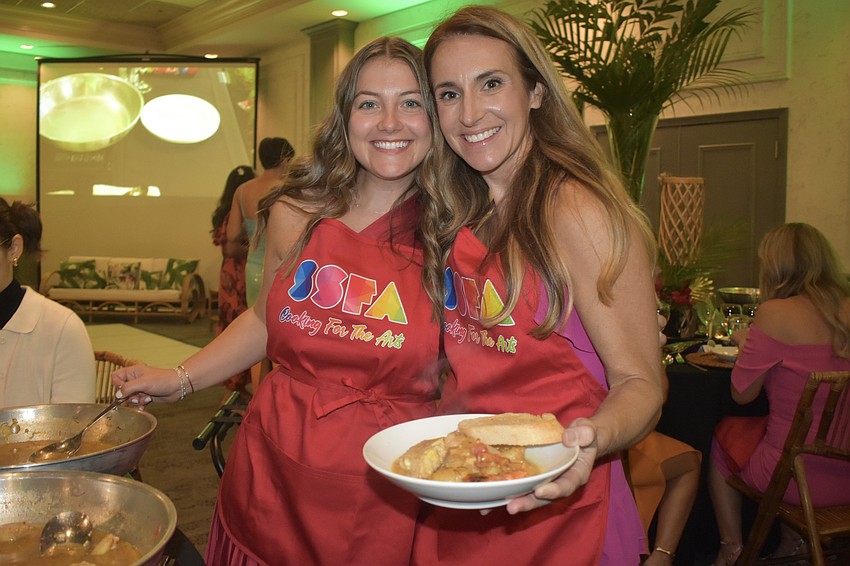Riley Hamilton and Christine Harrington cook seafood.