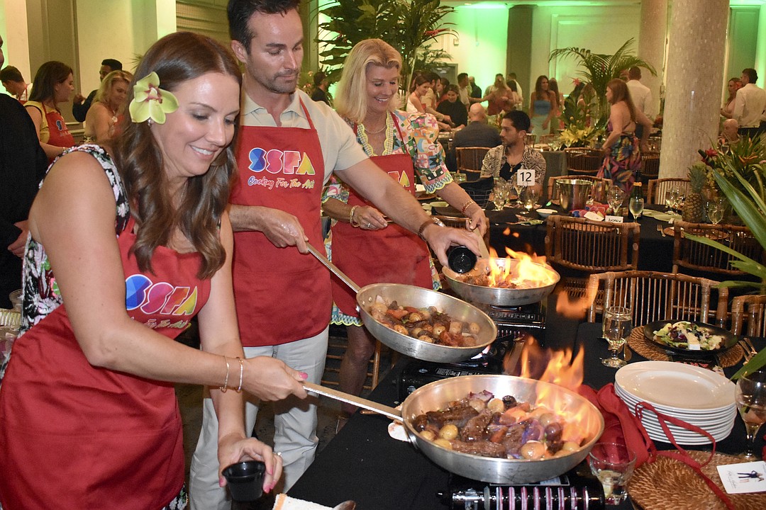 Parents and staff cook up meals in support of arts education