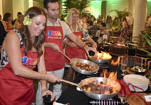 Molly Biter, Winfred Van Workum and Katie Moulton get the meal sizzling.