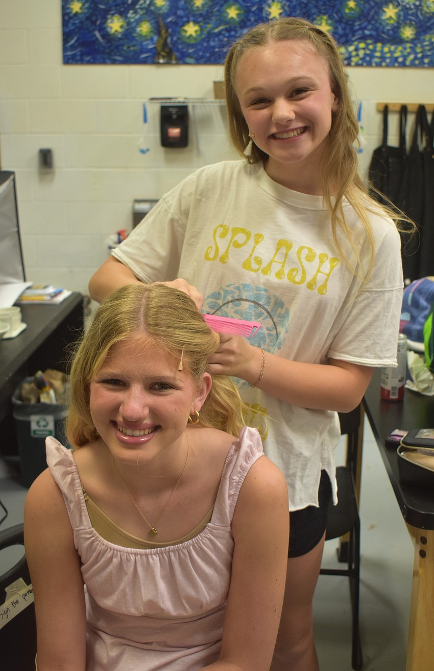 Reese Canterna styles the hair of Marleigh Matras before The Out-of-Door Academy production of 