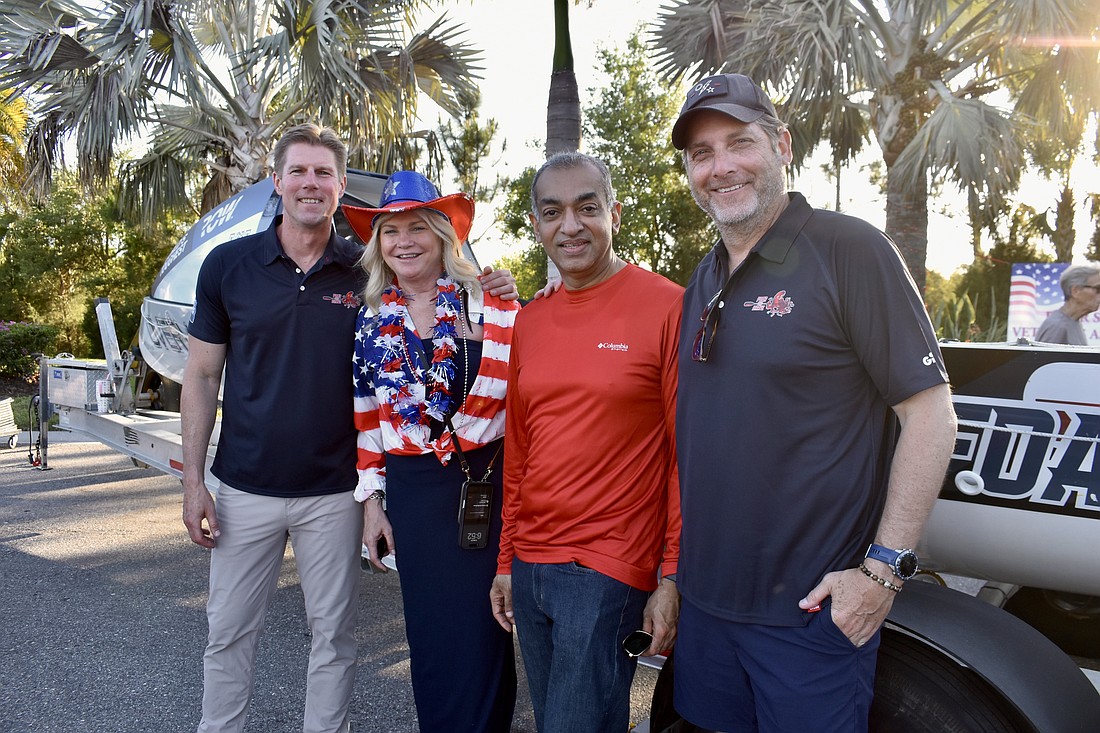 River Strand's Bonnie and Manoj Mathew stand between two of the crew members. John Pallasch is on the left and Joe Leach is on the right.