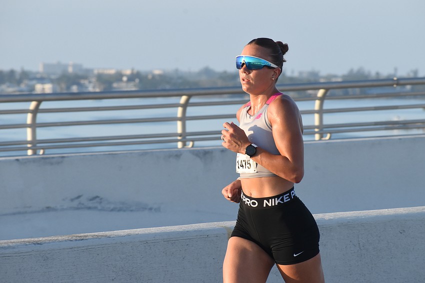 First place overall female Kianna Ferrazzini heads across the Ringling Bridge.