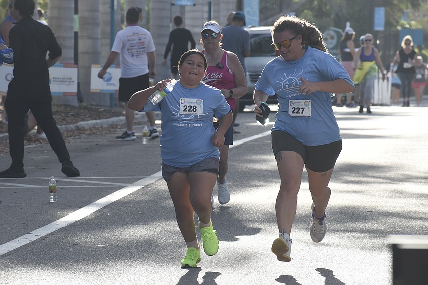 Letty Rose, a fourth grader at Sarasota Suncoast Academy, and Chelsea Rose, come in for the finish line.