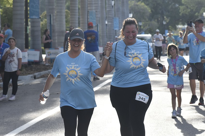 Heather Ferrigno and Kerri Deatherage reach the finish line.