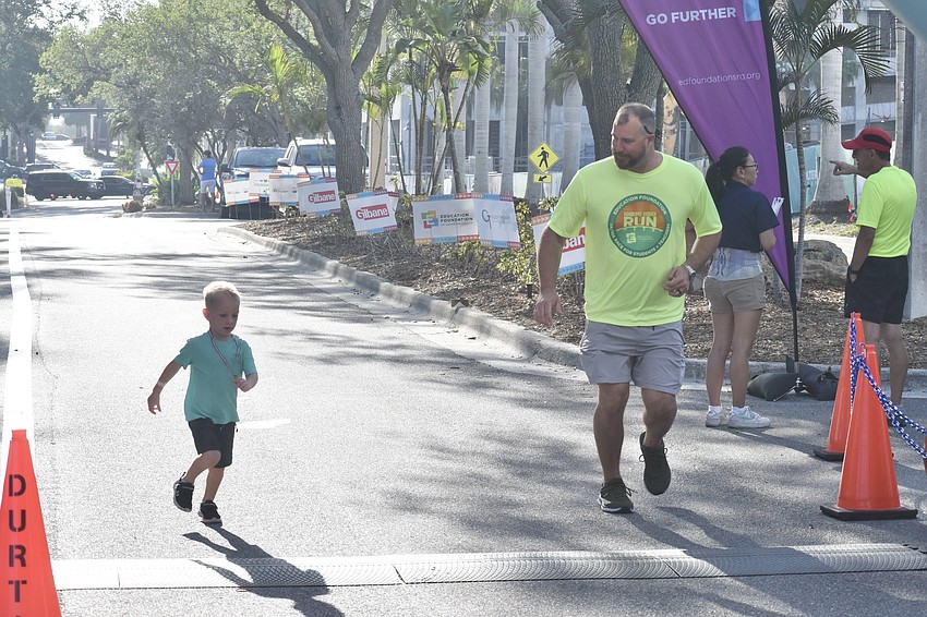 Ethan Hoover, 3, and his father Jordan Hoover, take a fun run.