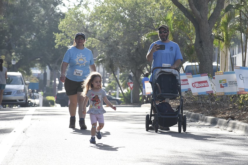Sarah Hubbard, Éowyn Hubbard and Brian Hubbard head for the finish line.