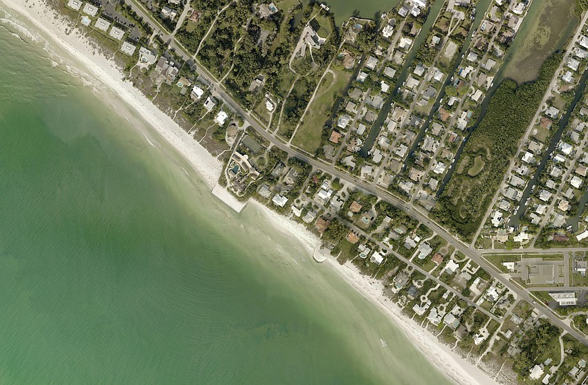 Sand can be seen built up to the north of and eroded to the south of the Ohana seawall in 2015 aerial imagery.