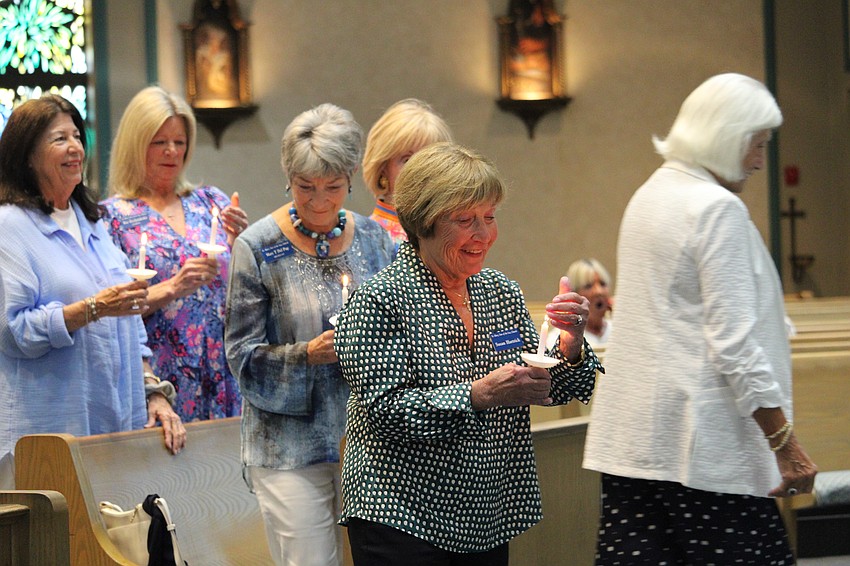 Susan Hartrick guards her candle flame.
