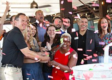 Surrounded by members of the Leadership Sarasota Class of 2026, staff from Save Our Seabirds and a cloud of confetti, Lisa Charles cuts the ribbon at the unveiling of an updated outdoor space at the bird sanctuary.