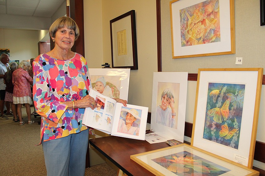 Artist Madeline Wikler's newest additions to her art display includes a book with examples of how she creates her watercolors.