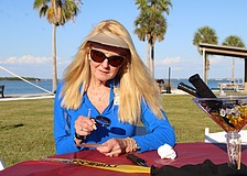 Susan Phillips, board chair of the Longboat Key Foundation and a Longboat Key Garden Club member, contemplatively peers through a clue-finding magnifying glass at the murder mystery-themed Dinner and a Movie fundraiser on April 24 at Bayfront Park. The event closed out this year's Arts in April programming.