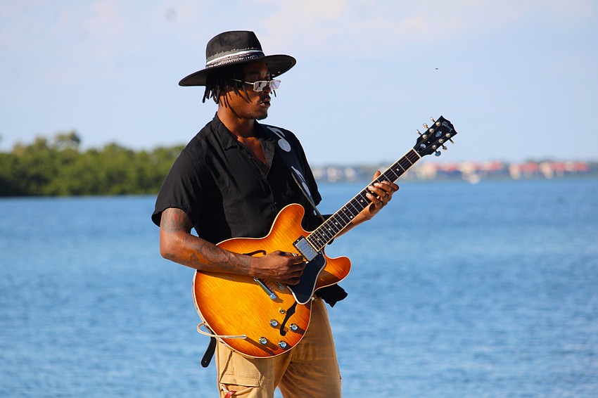 Musician Akiem Esdaile welcomes attendees to Dinner and a Movie overlooking Sarasota Bay.