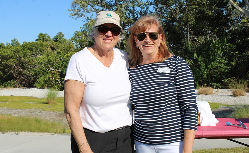 Catering chef Jean Caldwell and Longboat Key Garden Club president Melanie Dale welcome incoming guests to Dinner and a Movie.