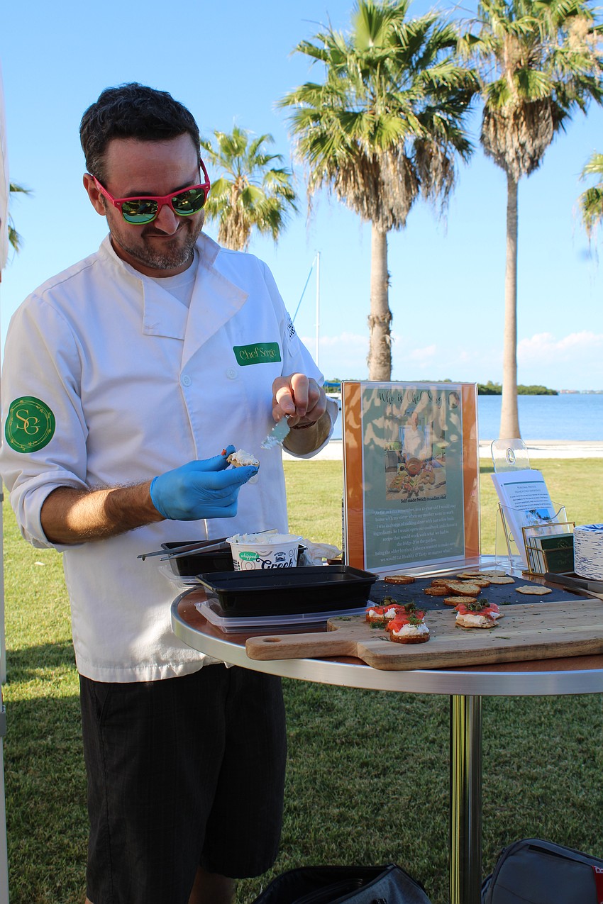 Serge Gauthier of Gauthier Salon & Wellness Center dishes up a smoked salmon appetizer at Dinner and a Movie. The business owner is branching out into private chef services, specializing in French Canadian cuisine.