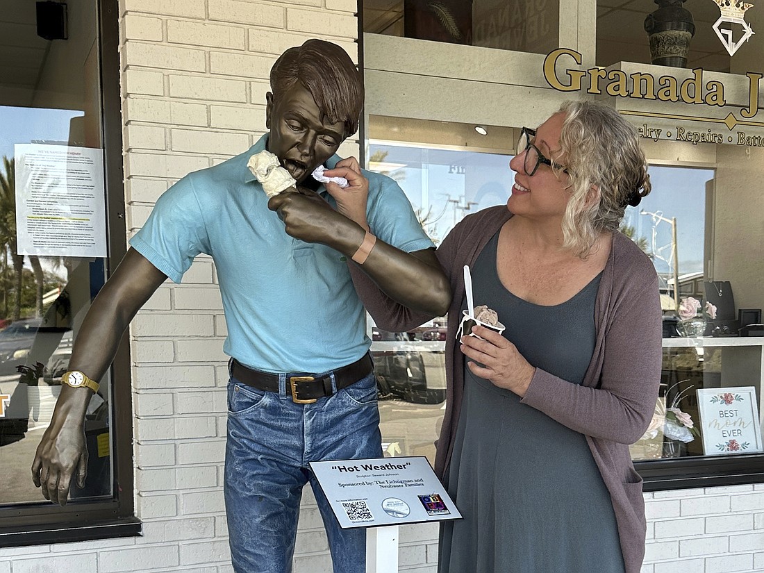 Melissa Guinta shows an example of the "Interact with a statue" category. Photo by Suzanne McCarthy