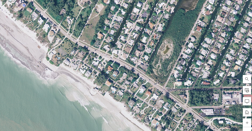 A beach renourishment project was underway in 2006, with sand being placed between the Gulf and the Ohana seawall as seen from aerial imagery.