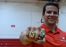 Coach Jared Clark shows off his 2023 (left) and 2025 (right) state championship rings. He's guided Cardinal Mooney to a 52-22 record since taking over ahead of the 2020 season.