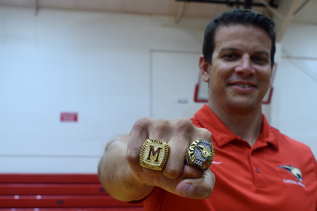 Coach Jared Clark shows off his 2023 (left) and 2025 (right) state championship rings. He's guided Cardinal Mooney to a 52-22 record since taking over ahead of the 2020 season.