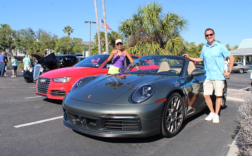 Sheila Loccisano greets Noel Ladd at the Cops, Cars and Coffee meetup. Ladd brought his Porsche 911 S Cabriolet 23, which he has in 