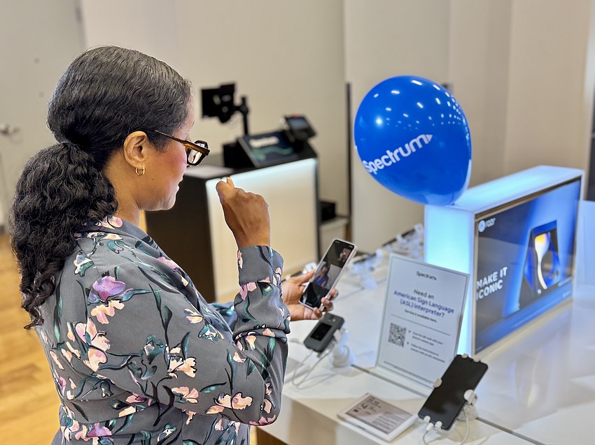 A woman uses the new ASL service in a Spectrum store. Courtesy photo