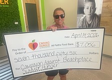 Volunteer Linda Gass helped organize a Beachplace fundraiser for All Faiths Food Bank, which included a golf tournament and tabletop games.