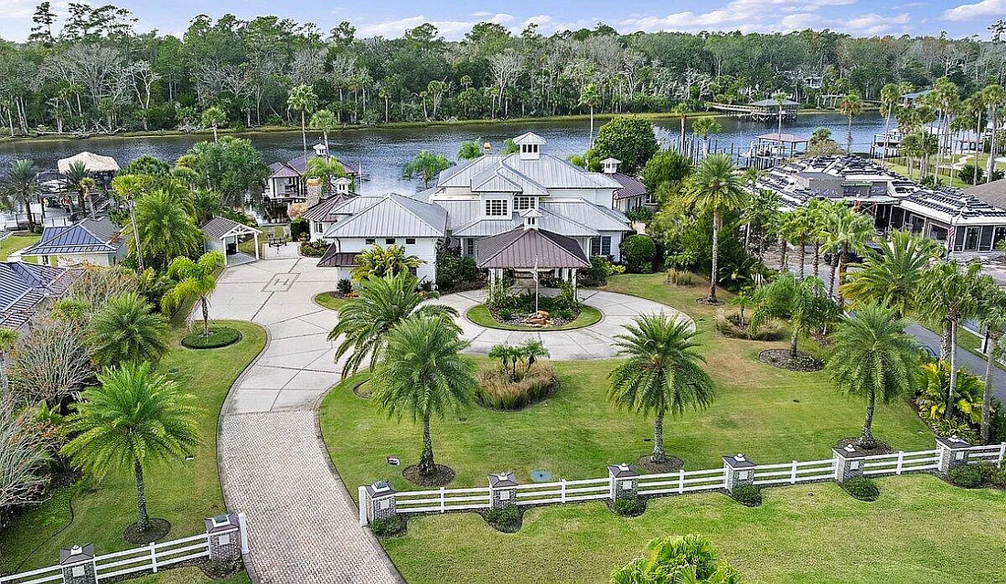 Intracoastal waterfront home features four bedrooms, five full and two half-bathrooms, a guest house, wine cellar, detached garage, pool, outdoor kitchen and covered dock with boat lifts.