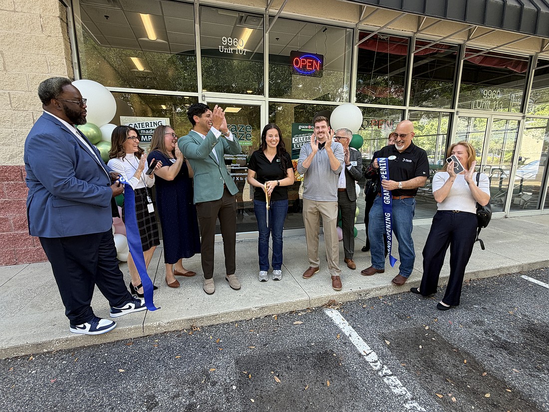 Staff and supporters celebrate the opening of the Graze Craze charcuterie shop in Jacksonville with a ribbon-cutting ceremony April 29, 2026.