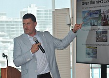 Casey Gonzmart Jr. explains a PowerPoint slide to the club.
