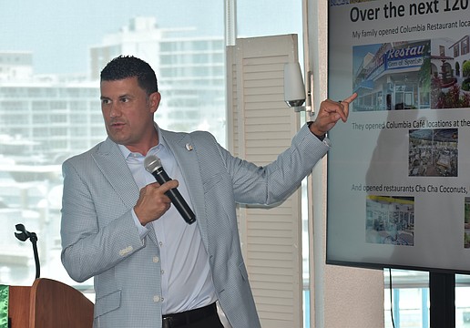 Casey Gonzmart Jr. explains a PowerPoint slide to the club.
