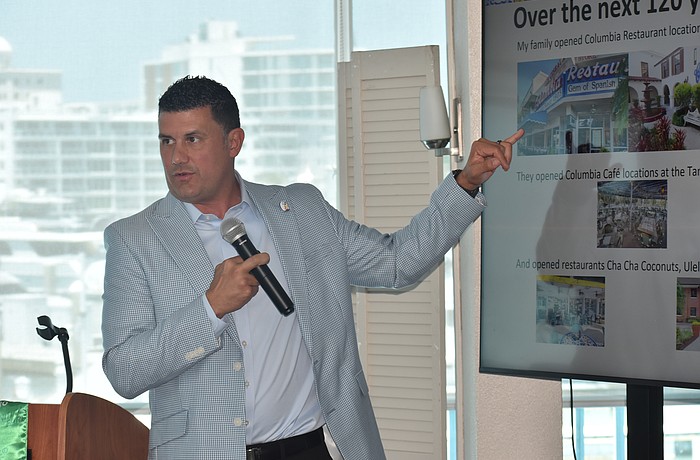 Casey Gonzmart Jr. explains a PowerPoint slide to the club.
